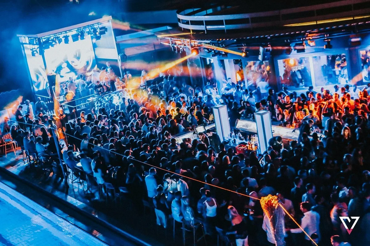 Crowd dancing under lights at an open-air nightclub